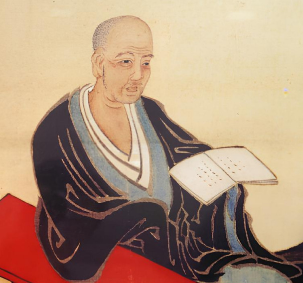 Illustrated portrait of Honinbo Dosaku holding a book, legendary Japanese Go player