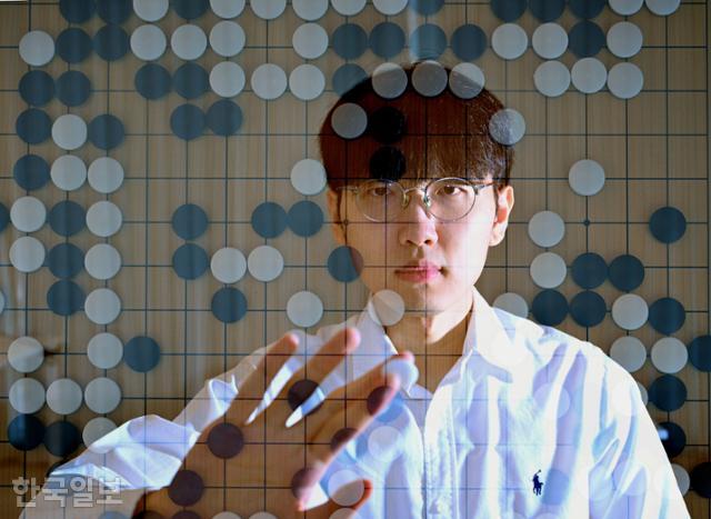 Abstract visualization of a Go board with black and white stones overlaid on a player’s face, symbolizing deep strategic thinking