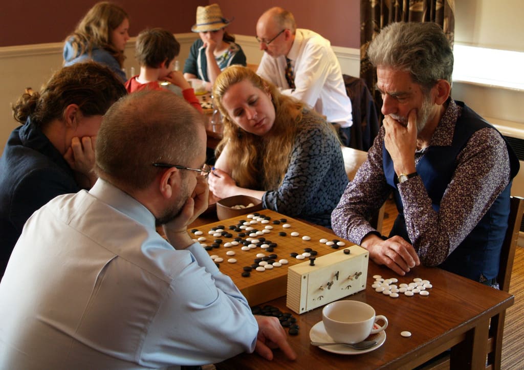 Group of players concentrating during a Go match at a local club gathering