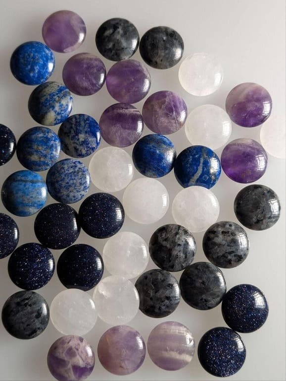 A rare set of Go stones made from various gemstones including amethyst and quartz.