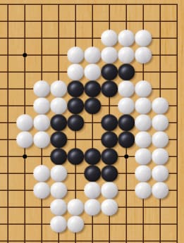 Go board diagram showing a dense black-and-white stone position forming a compact shape in the center area.
