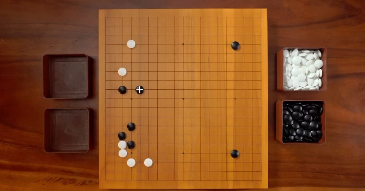 Overhead view of a Go board showing a position with a highlighted move marker