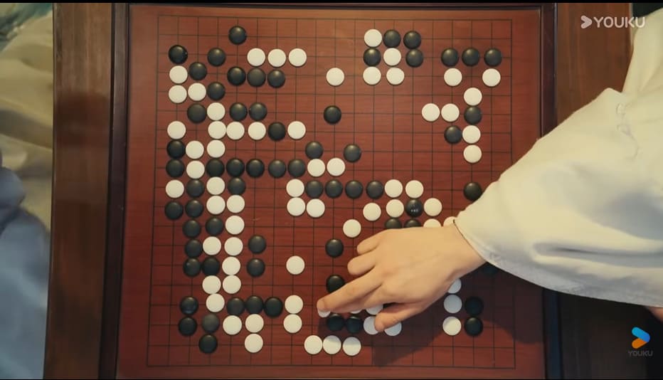 Close-up of a Go position in Dashing Youth with black and white stones spread across the board during play.