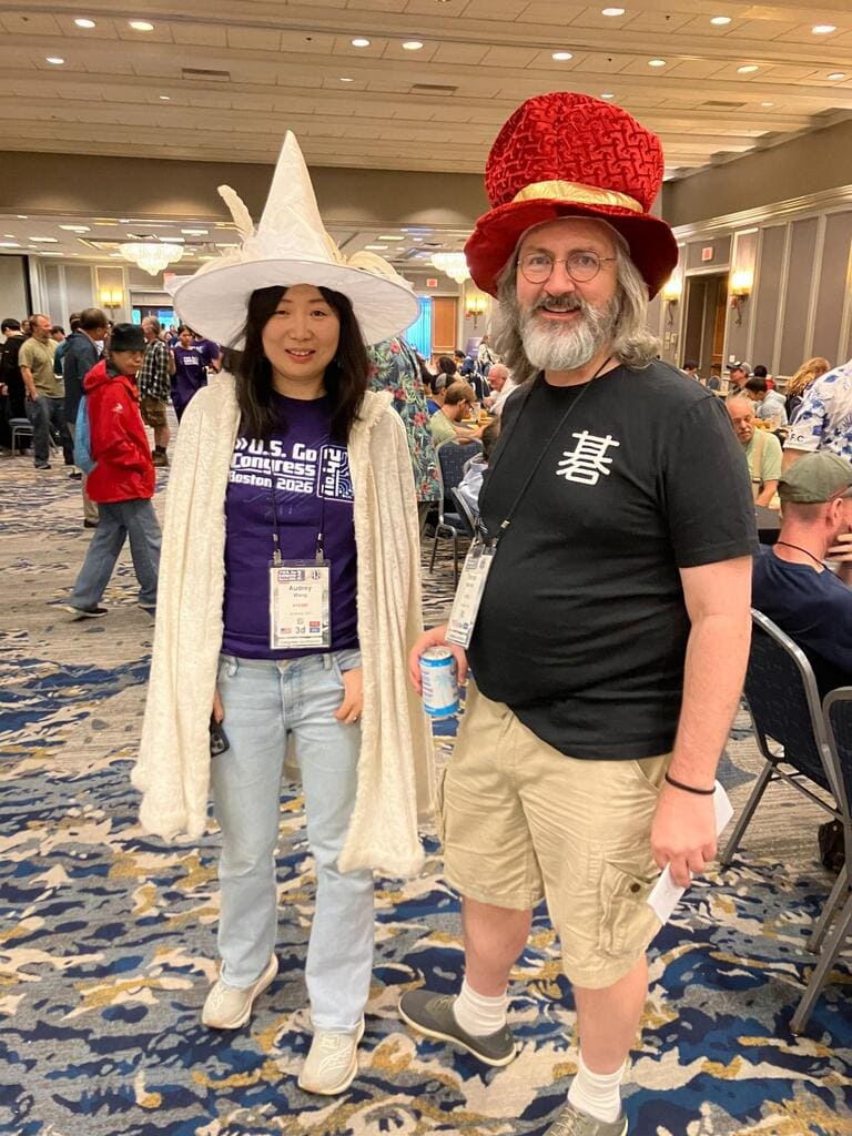 Audrey Wang and Trevor Morris wearing oversized hats at the 2026 U.S. Go Congress in Boston.
