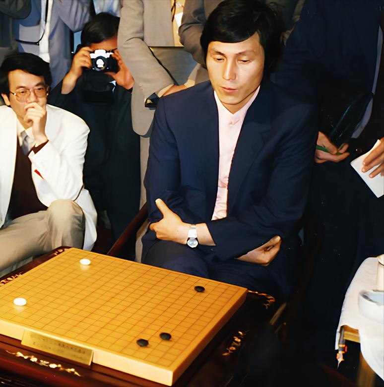 Cho Hunhyun sitting at the Go board during a tournament, surrounded by spectators
