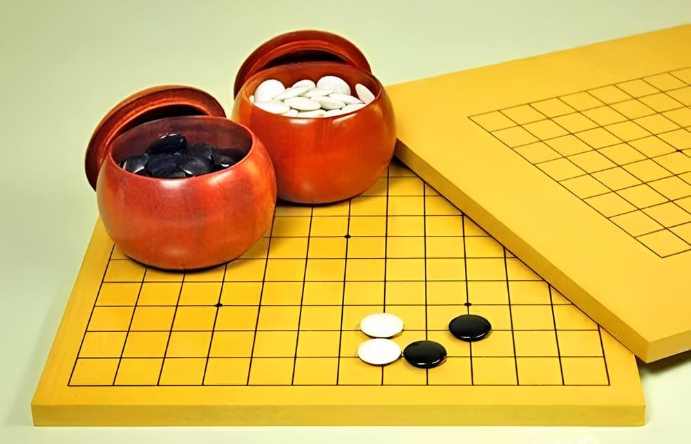 Close-up of a 9x9 Go board with black and white stones, used for teaching Go, Baduk, or Weiqi to beginners
