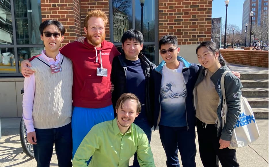 Group of Go players standing together outdoors during a community event