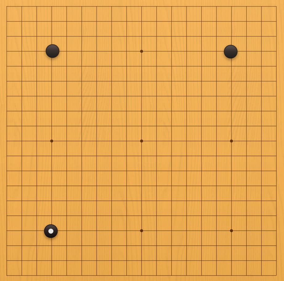 Go board diagram showing a three-stone handicap position with black stones placed on star points before play begins.