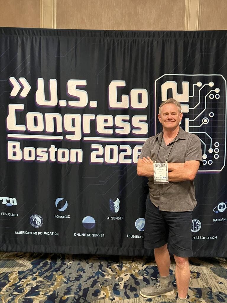 Eric Wainwright standing with his arms folded in front of the U.S. Go Congress Boston 2026 banner.
