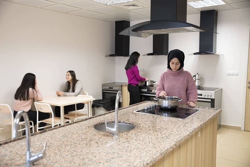 Residents preparing food and talking in a shared kitchen at Hacettepe University’s Beytepe Campus