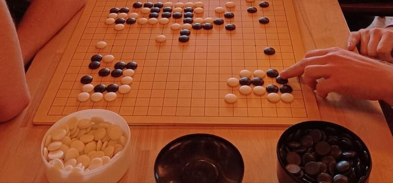 An AGF (American Go Foundation) demonstration Go board in use, showing a sample game.