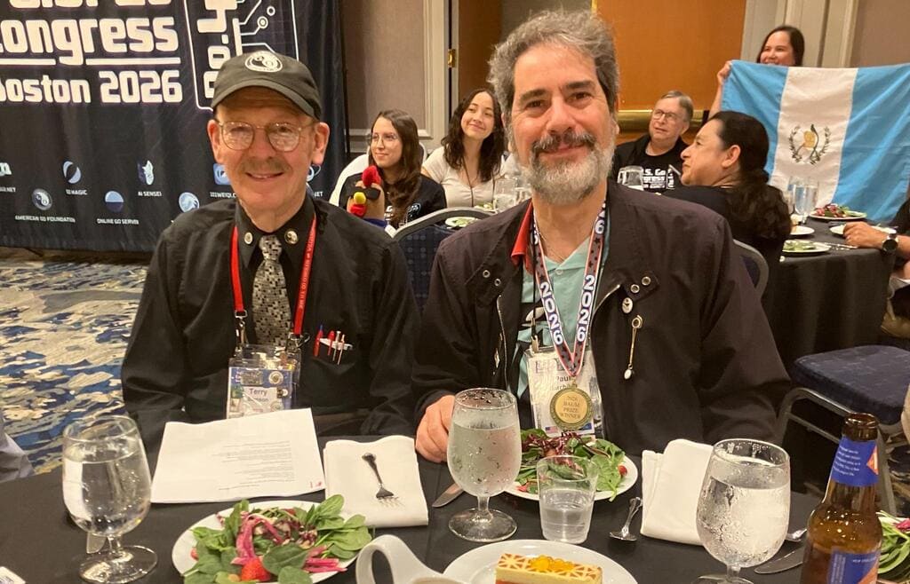 Two participants smiling at a banquet table during the 2026 U.S. Go Congress in Boston.