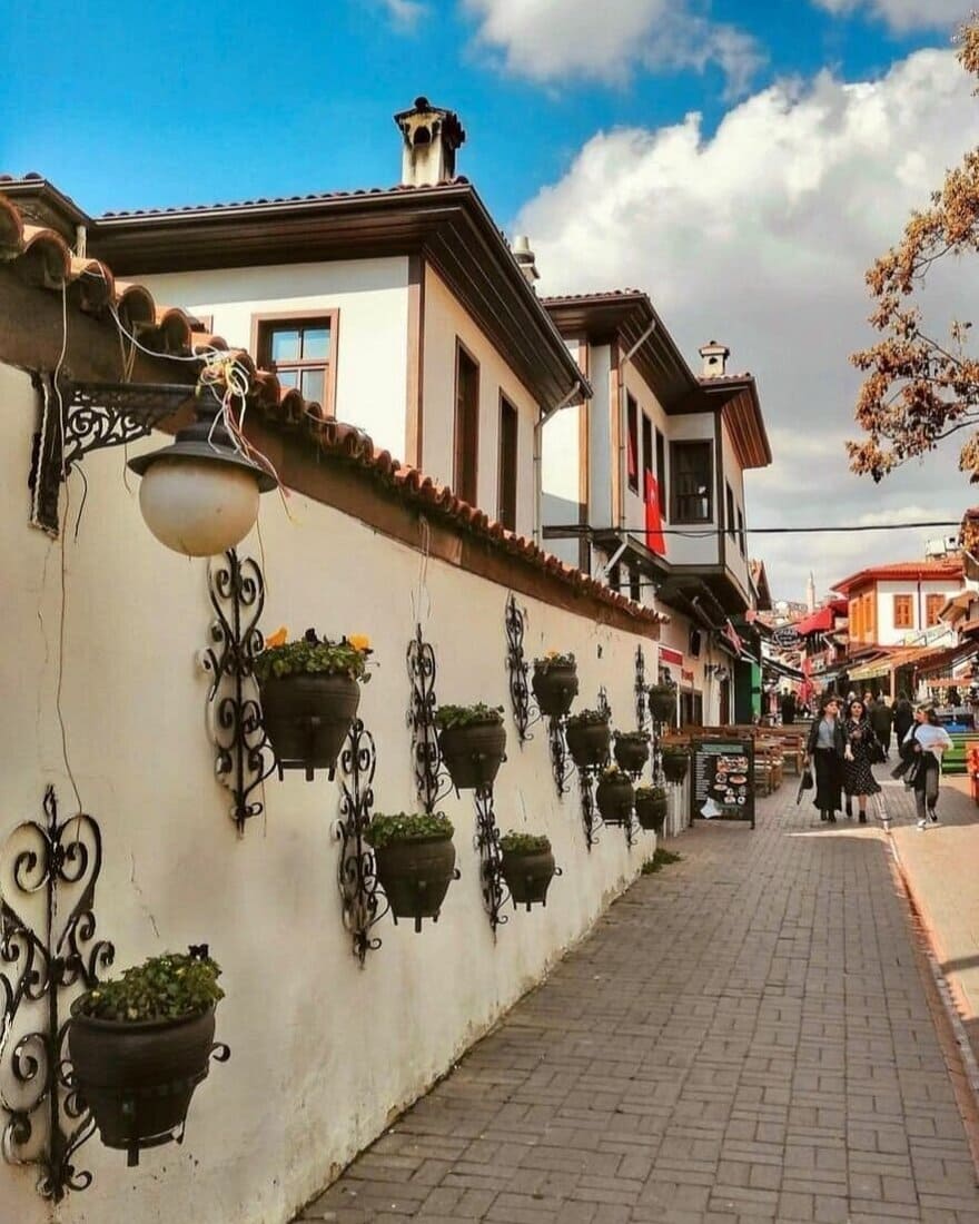 A narrow pedestrian street lined with restored traditional houses in Ankara