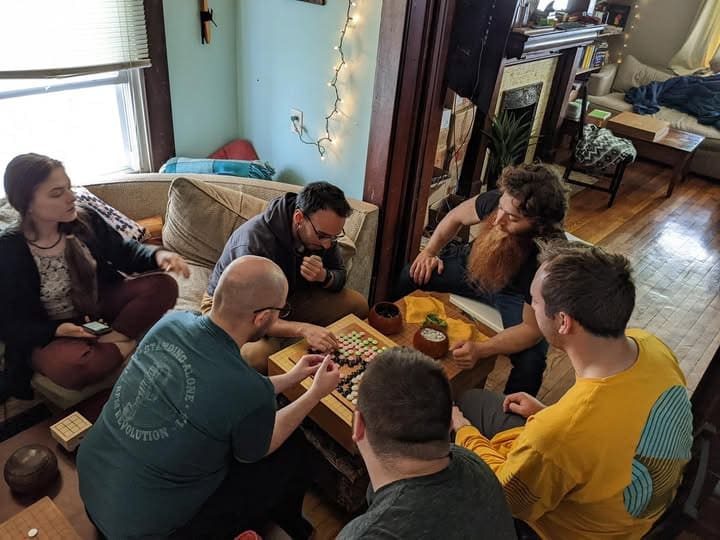 Group of people playing Go together during a casual home gathering