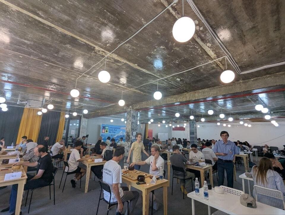Wide view of the main tournament hall filled with Go players during the Issyk-Kul Cup.
