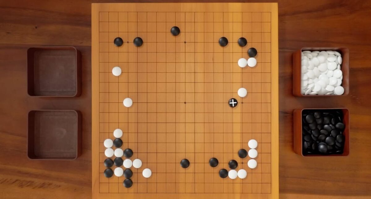 Go board showing an early opening position with a highlighted move marker