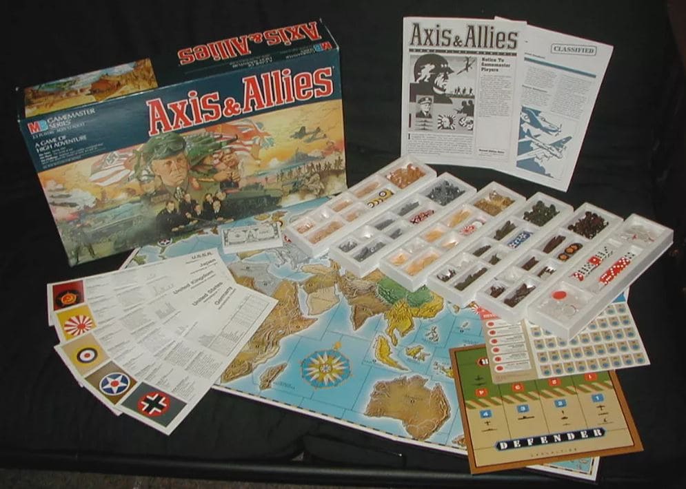 Axis & Allies board game layout with pieces representing military units, world map, and rulebooks, prepared for strategic World War II gameplay.