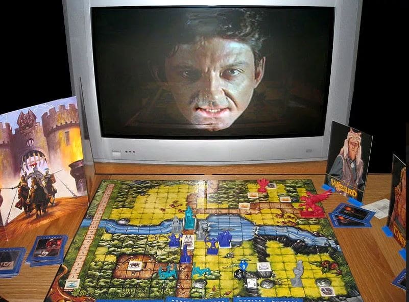 Dragon Strike board game in action, featuring a dungeon layout with character figures and a menacing face on the TV screen.