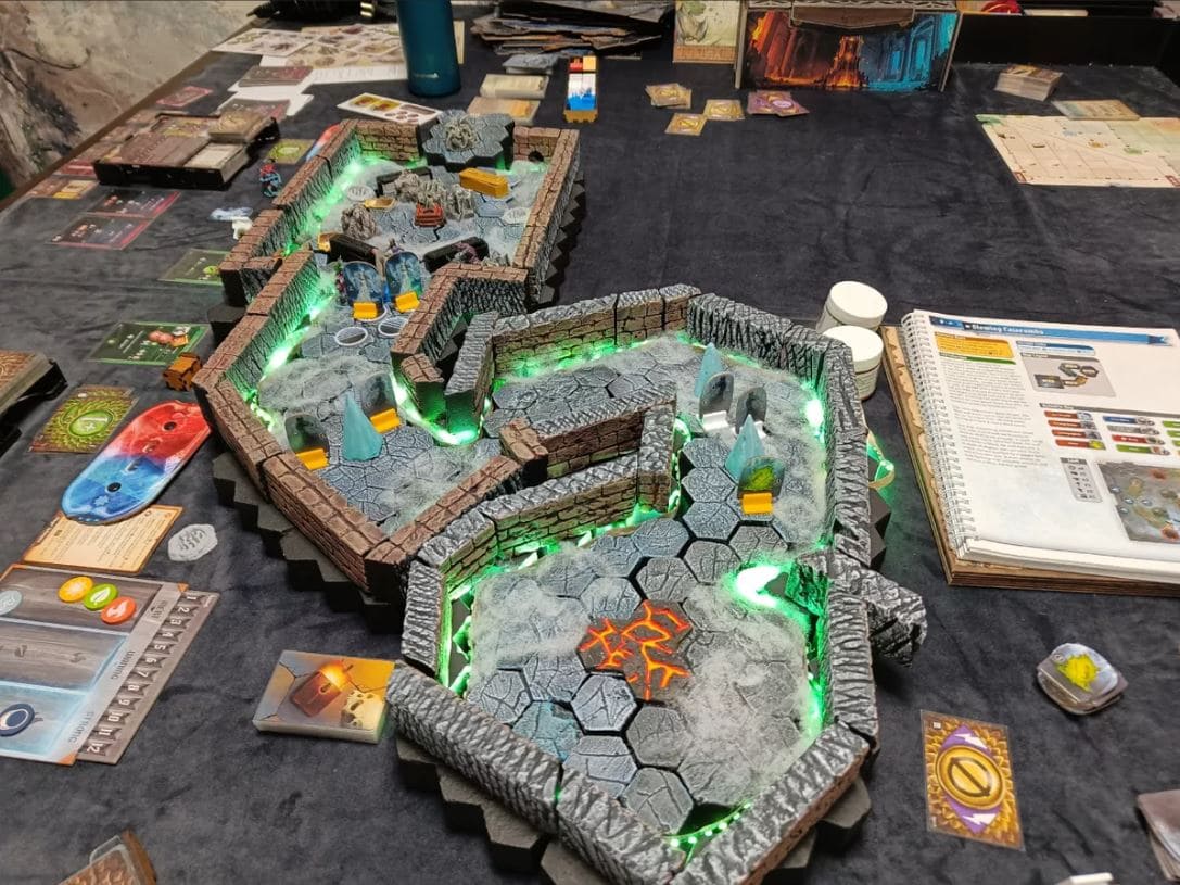 A Frosthaven dungeon in mid-game, with players navigating the intricate map and components in a fantasy setting.