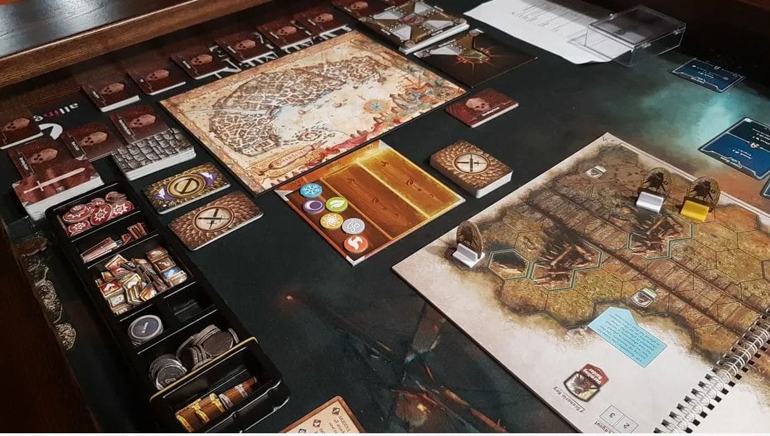 The setup of Gloomhaven: Jaws of the Lion, showcasing its tactical map, cards, and tokens ready for players to engage in strategic play.