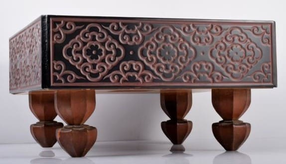 Ornate antique Go board with red carvings and elevated wooden legs