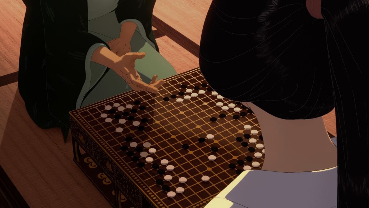 Two people seated across a Go board, engaged in a game of strategy with black and white stones.