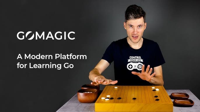 GoMagic promotional image featuring an instructor explaining Go strategies with a Go board in front of him, alongside the text "A Modern Platform for Learning Go."