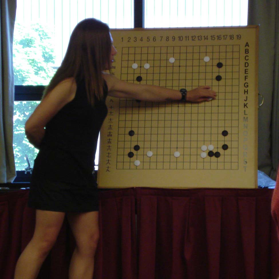 Janice Kim explaining a Go game position on a large demonstration board