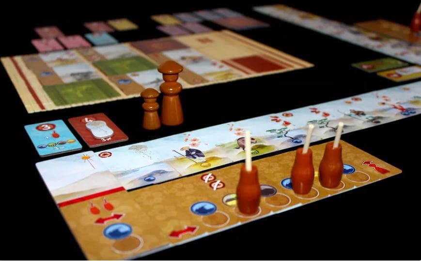 Kanagawa board game with detailed components and player pieces on a table during gameplay.