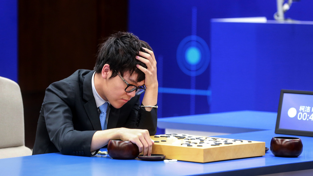 Ke Jie, deep in thought, playing against DeepMind’s AlphaGo in a high-stakes professional Go match.