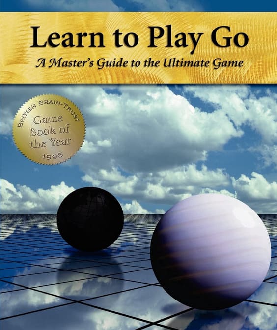 Cover of the book 'Learn to Play Go: A Master’s Guide to the Ultimate Game' featuring abstract spheres and a cloudy sky.