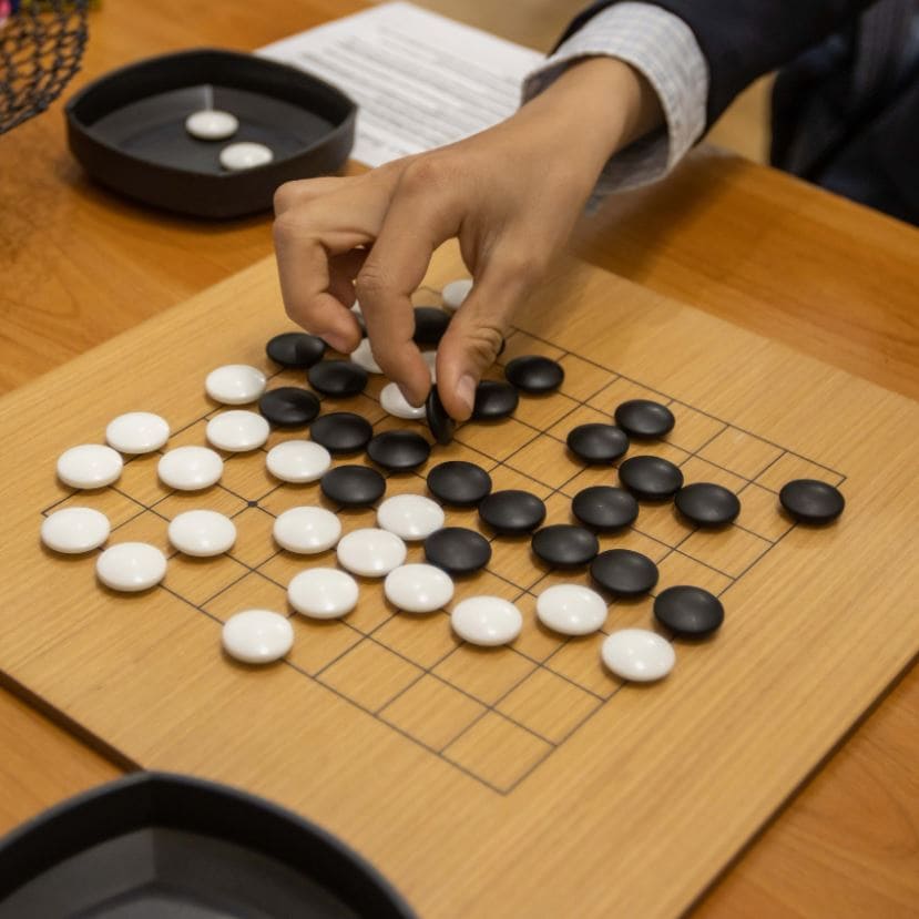 A Go board with strategic pieces placed, symbolizing strategic thinking and planning.