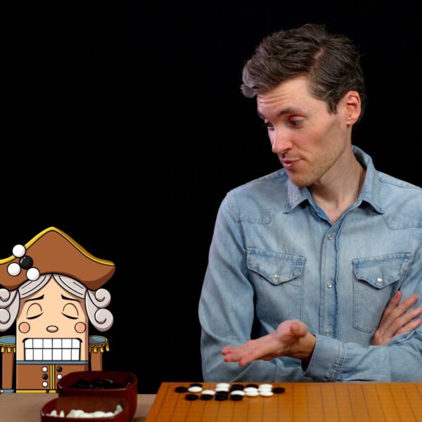 A man in a blue shirt discusses a Go move with a cartoon general character