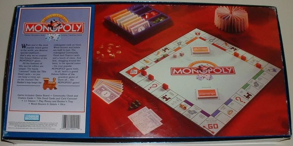 A 90s edition of Monopoly with a redesigned game board and classic property cards, along with colorful paper money and game tokens.