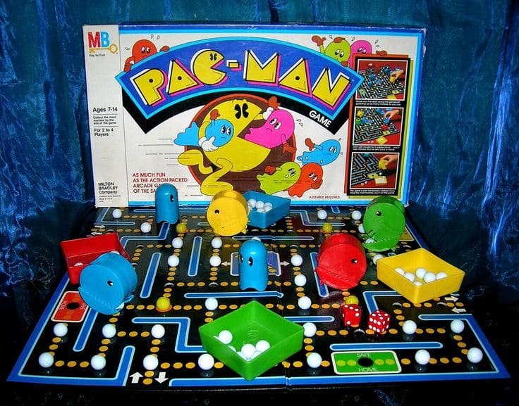 The Pac-Man board game from the 1980s featuring colorful Pac-Man pieces and a maze-like game board.