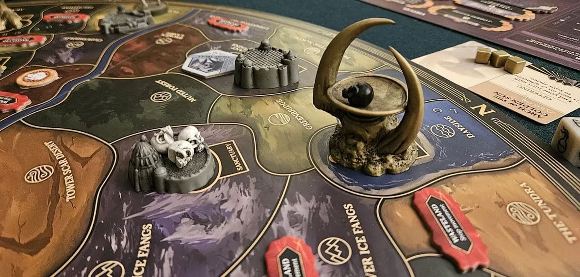 Close-up view of the board and miniatures from the game Return to Dark Tower, featuring a dark fantasy landscape with various regions and landmarks.