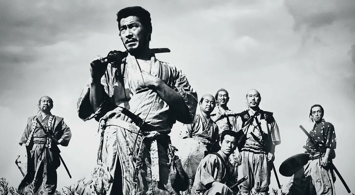 A black-and-white image of seven samurai standing together, from the iconic film "Seven Samurai" by Akira Kurosawa.