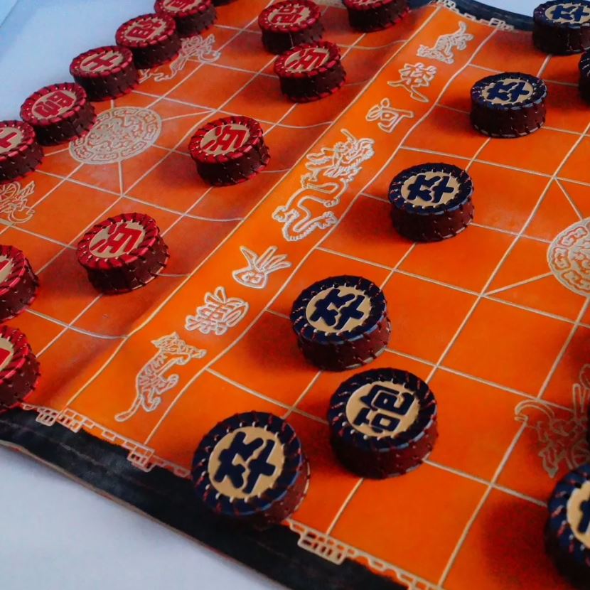 A Xiangqi (Chinese chess) board with pieces set up for a game.